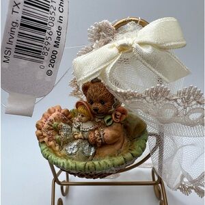 Vintage 2000 ornament . Teddy In bassinet with doll.